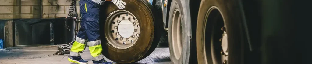A tech rolling a truck tire