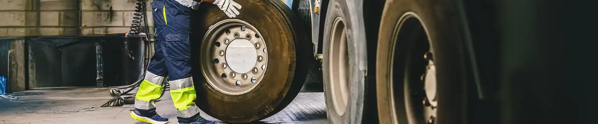 A tech rolling a truck tire