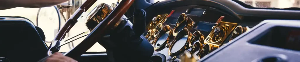 A truck's interior console, dash, and gauges.
