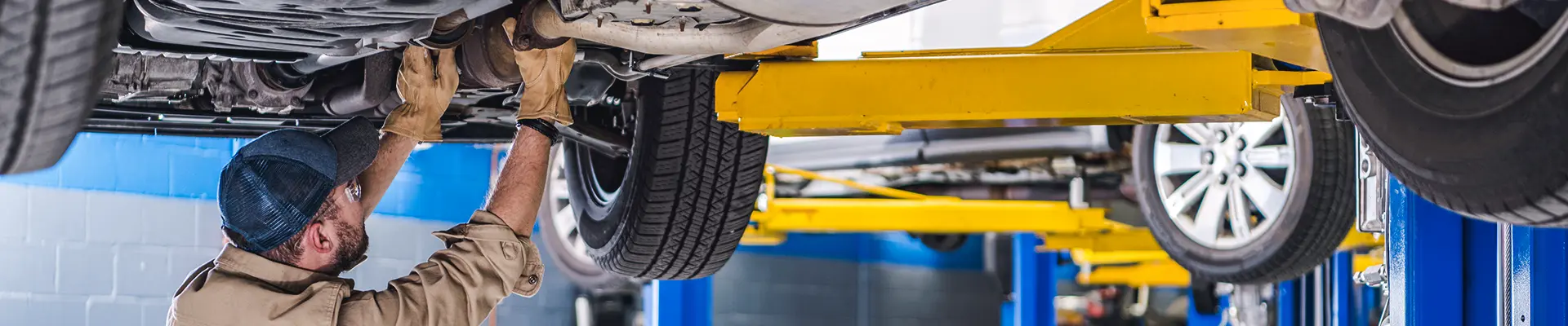 A technician working under a vehicle.