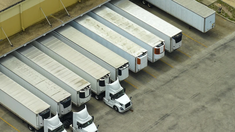 trucks-at-a-loading-dock-waiting-for-delivery Semi trucks at a loading dock